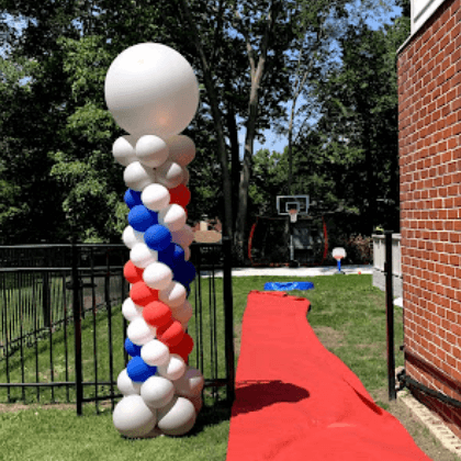 White, green, and red balloon column